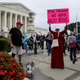 A protester demonstrates at the US Supreme Court on Brett Kavanaugh’s first day as a justice.